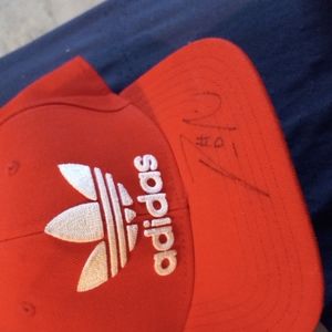 Red and green adidas hat signed by damian lillard